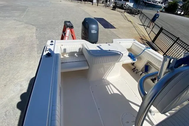 Slide: The Image of 2004 Sea Hunt Triton 220 boat interior with seating and Yamaha 150 outboard motor. - 8