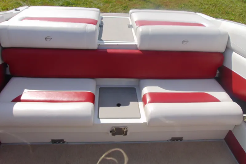 Slide: The Image of 2013 Crownline 235 SS boat interior with red and white seating, open storage compartment. - 10
