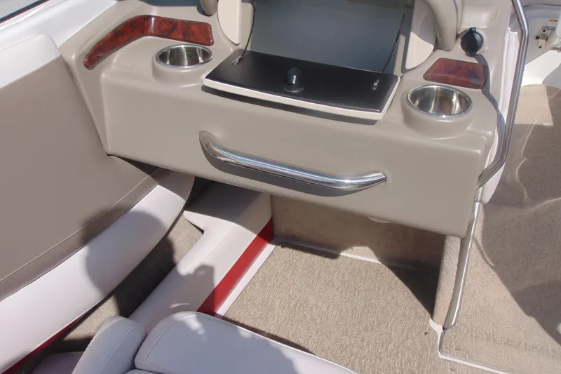 Slide: The Image of 2013 Crownline 235 SS boat interior with cup holders and beige seating. - 18