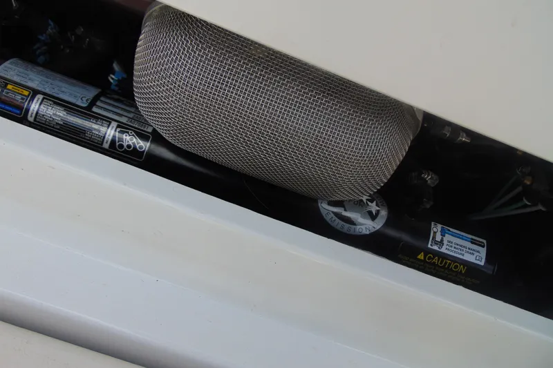 Slide: The Image of Engine compartment of 2013 Crownline 235 SS boat, showing exhaust and caution labels. - 21