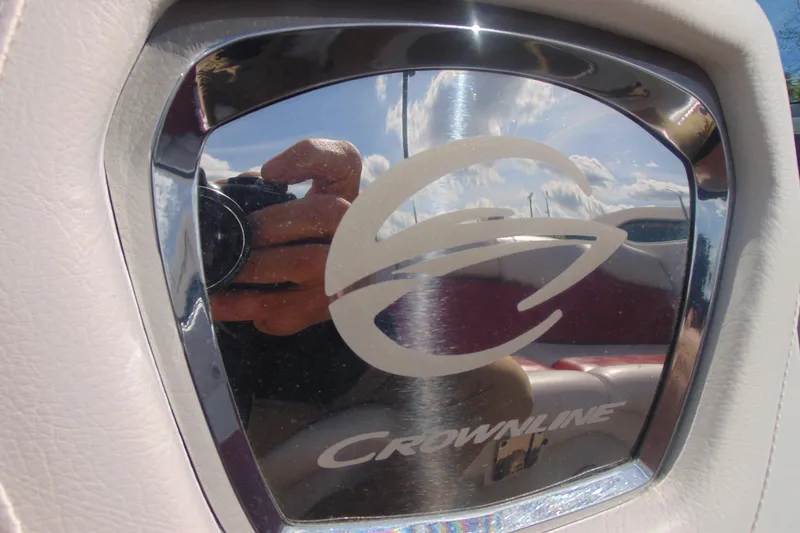 Slide: The Image of Crownline 235 SS 2013 logo on reflective surface with sky reflection. - 23