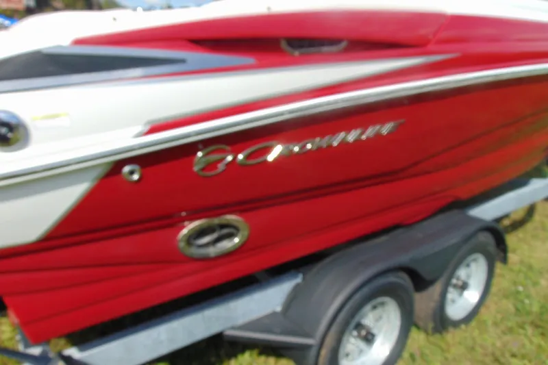 Slide: The Image of 2013 Crownline 235 SS boat in red and white on a trailer. - 4