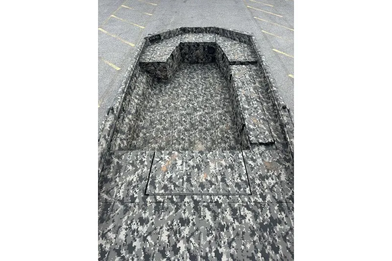 Slide: The Image of Camouflage-patterned interior of a 2025 Havoc 1656 boat in a parking lot. - 6