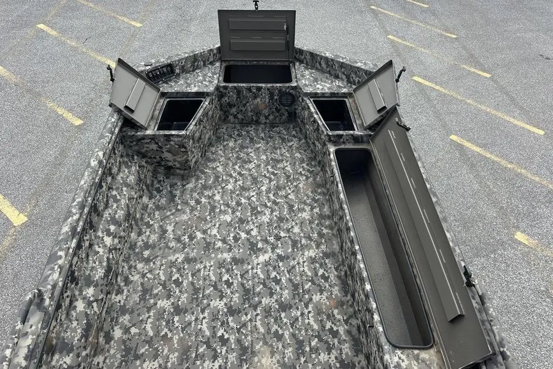 Slide: The Image of 2025 Havoc 1656 boat interior with open storage compartments, digital camouflage design. - 7