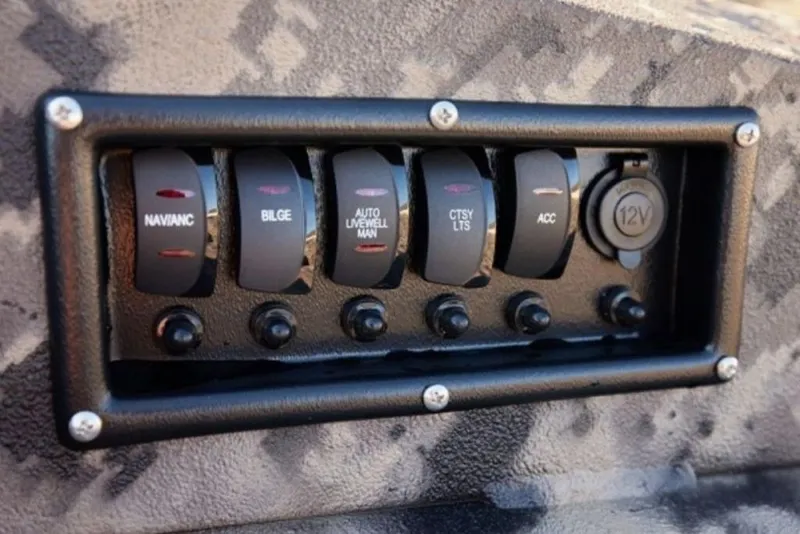 Slide: The Image of Control panel of a 2025 Havoc 1656 boat with labeled switches and 12V outlet. - 9