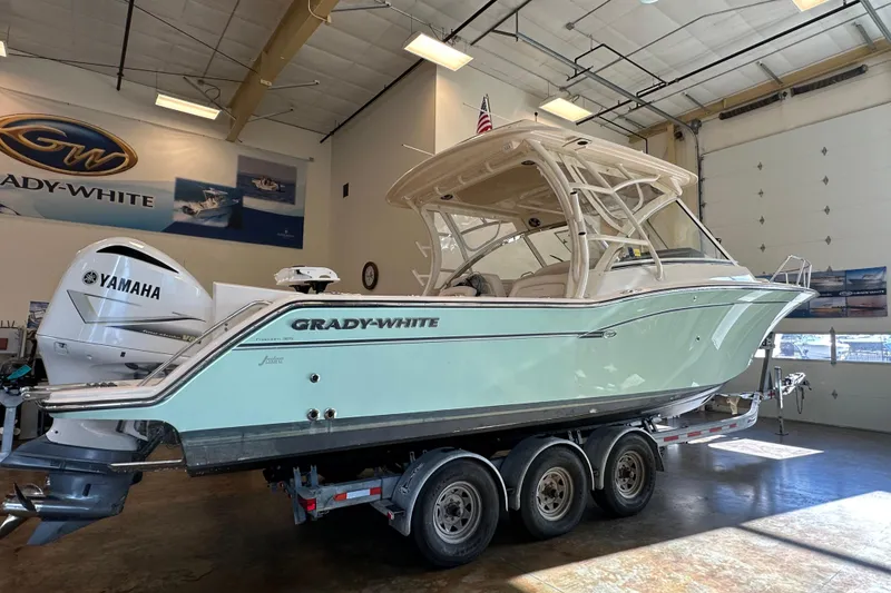 The Image of 2019 Grady-White Freedom 325 boat in showroom, featuring Yamaha engines. - 1