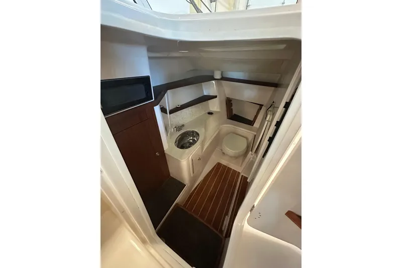 Slide: The Image of 2019 Grady-White Freedom 325 boat interior with compact bathroom amenities. - 12