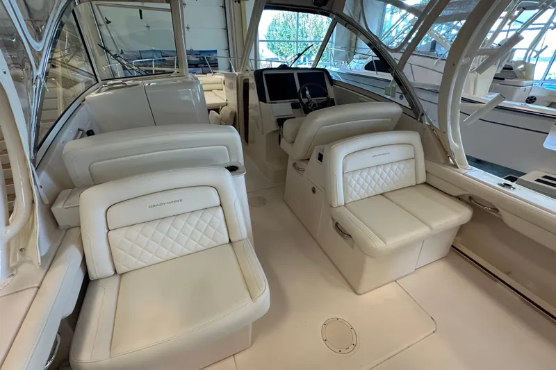 Slide: The Image of 2019 Grady-White Freedom 325 boat interior with luxurious seating and helm station. - 17