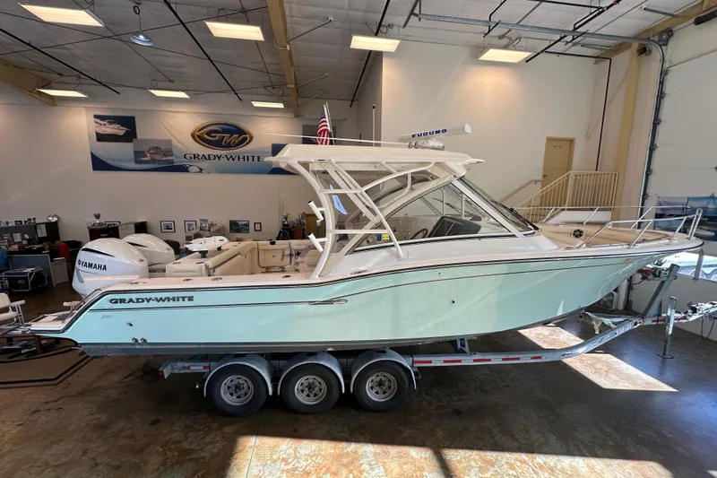 Slide: The Image of 2019 Grady-White Freedom 325 boat on trailer in showroom, side view. - 3