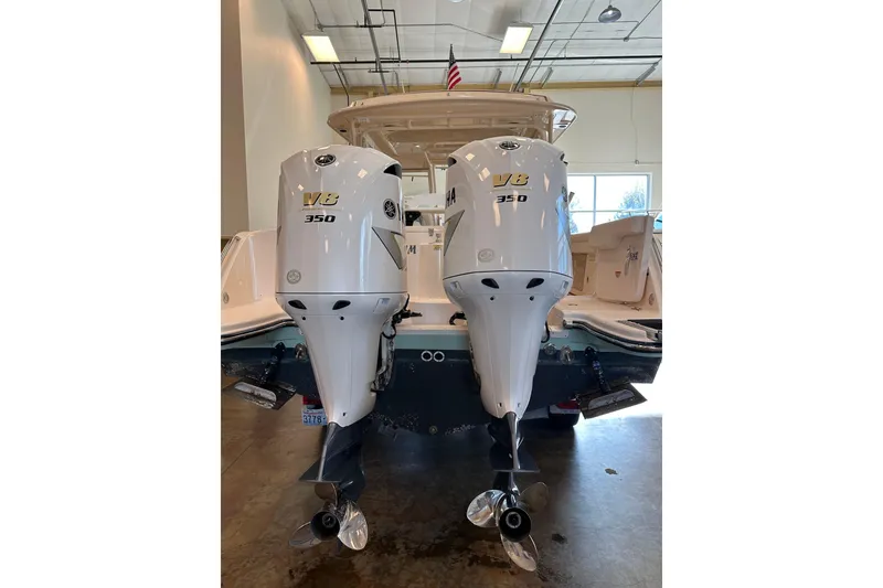 Slide: The Image of 2019 Grady-White Freedom 325 with twin Yamaha V8 350 engines in a showroom. - 4