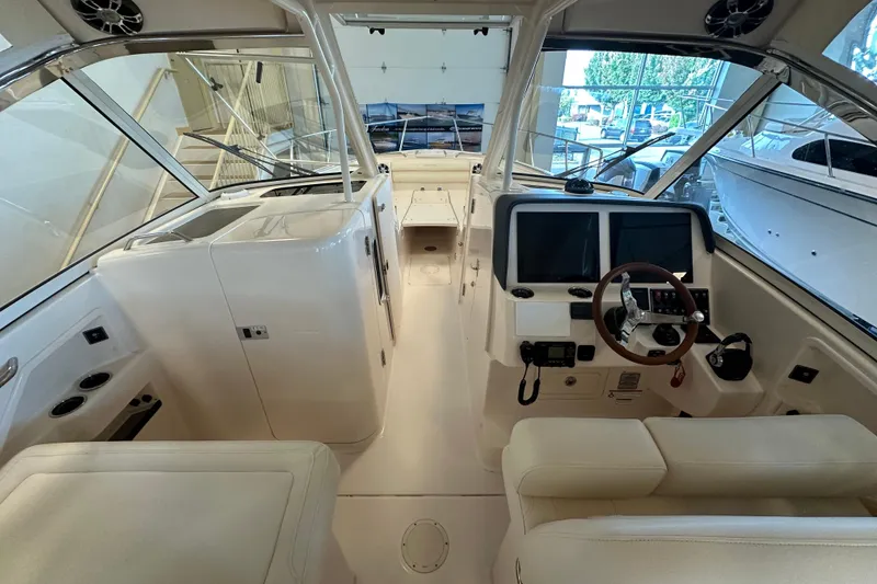 Slide: The Image of 2019 Grady-White Freedom 325 boat interior with helm, seating, and controls. - 9