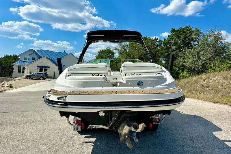 Slide: The Image of 2011 Rinker 276 Captiva boat on trailer, sunny day, residential background. - 11
