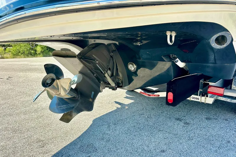 Slide: The Image of 2011 Rinker 276 Captiva boat propeller and stern drive on a trailer. - 14