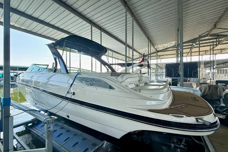 Slide: The Image of 2011 Rinker 276 Captiva boat docked in covered marina, side view. - 16