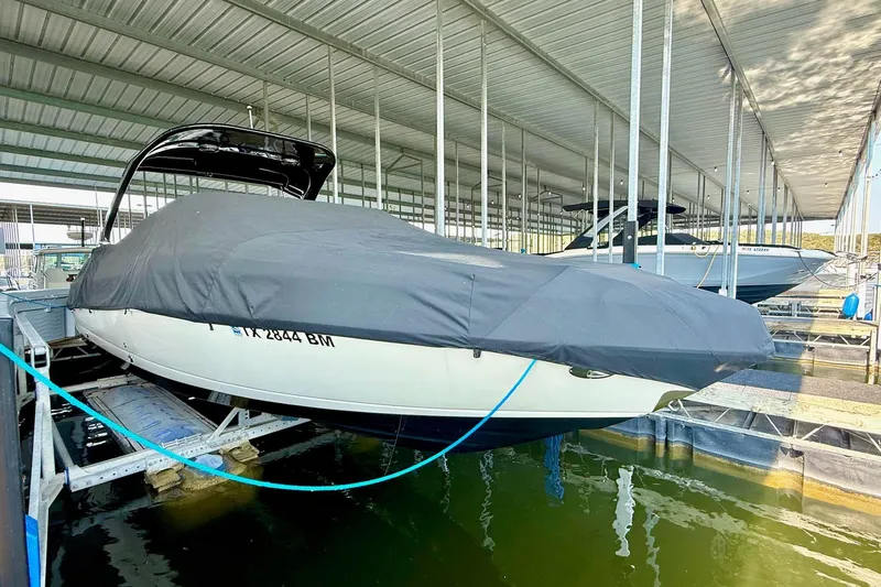 Slide: The Image of 2011 Rinker 276 Captiva boat covered and docked in a marina. - 17