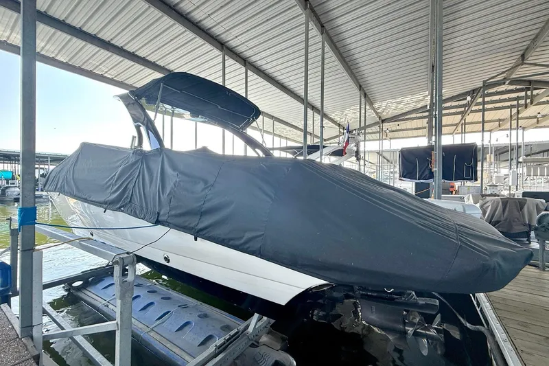 Slide: The Image of 2011 Rinker 276 Captiva boat covered in a marina dock. - 18