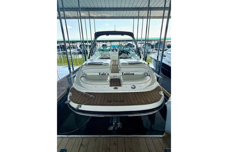 Slide: The Image of 2011 Rinker 276 Captiva boat docked, rear view with custom name "Yale's Tuition." - 19