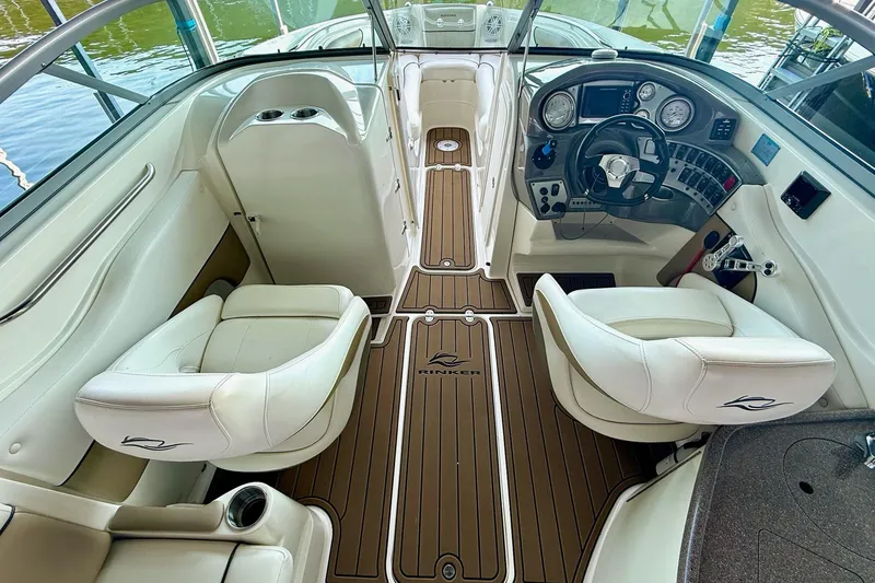 Slide: The Image of Interior of 2011 Rinker 276 Captiva boat with white seating and wood flooring. - 25