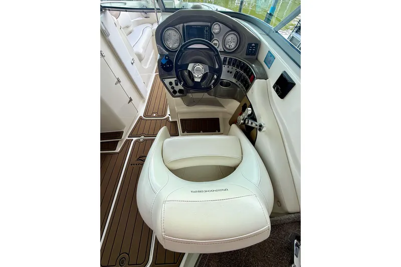 Slide: The Image of 2011 Rinker 276 Captiva boat cockpit with steering wheel and gauges. - 26