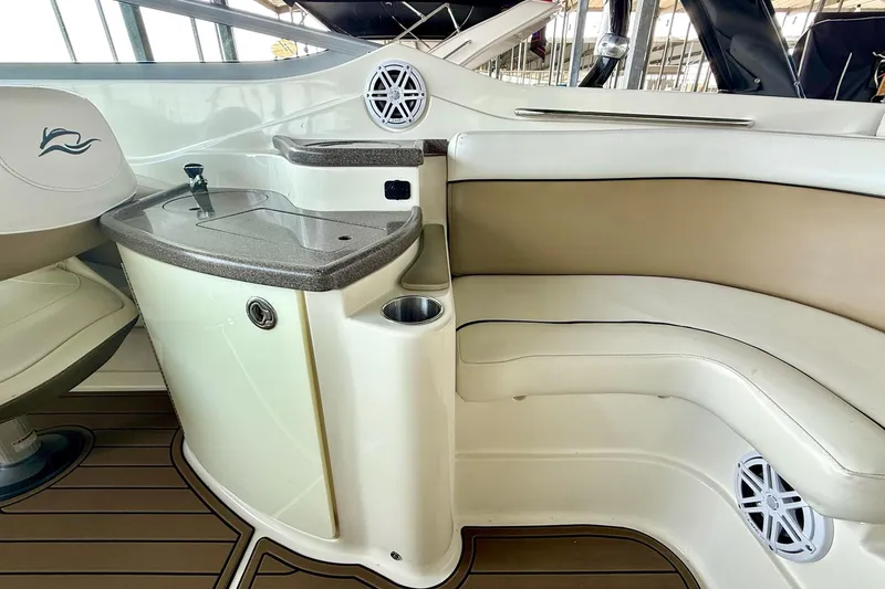 Slide: The Image of 2011 Rinker 276 Captiva boat interior with seating and built-in sink. - 28