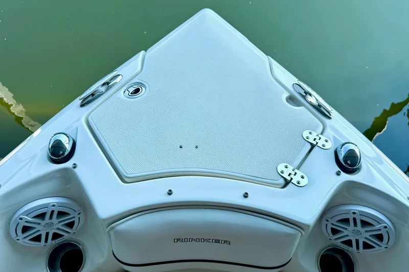 Slide: The Image of Bow of 2011 Rinker 276 Captiva boat with speakers and hatch, on calm water. - 29