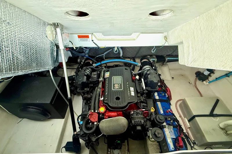 Slide: The Image of Engine compartment of a 2011 Rinker 276 Captiva boat, featuring a Volvo Penta engine. - 37