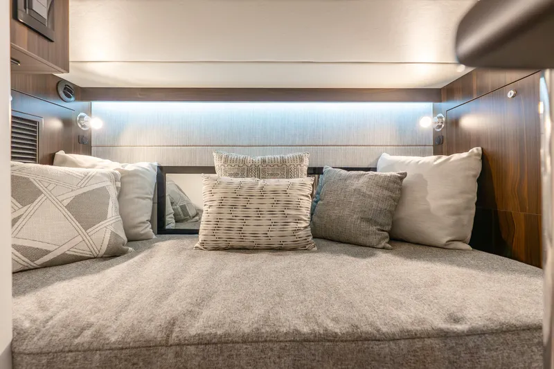 Slide: The Image of Luxurious cabin interior of 2024 Cruisers Yachts 34 GLS OB with plush pillows. - 13