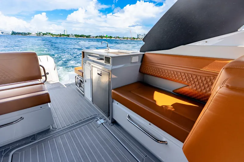 Slide: The Image of 2024 Cruisers Yachts 34 GLS OB interior with leather seating and ocean view. - 20