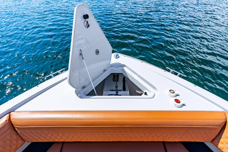 Slide: The Image of 2024 Cruisers Yachts 34 GLS OB bow with open hatch, on calm water. - 27