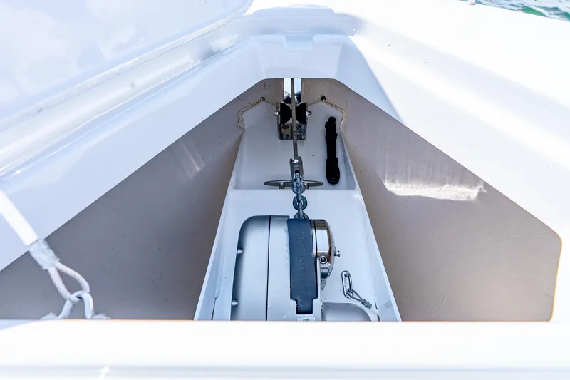 Slide: The Image of Anchor compartment of 2024 Cruisers Yachts 34 GLS OB, showcasing winch and chain. - 28