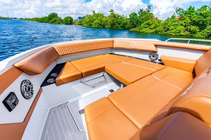 Slide: The Image of Luxurious seating on 2024 Cruisers Yachts 34 GLS OB, featuring tan upholstery and scenic water view. - 30