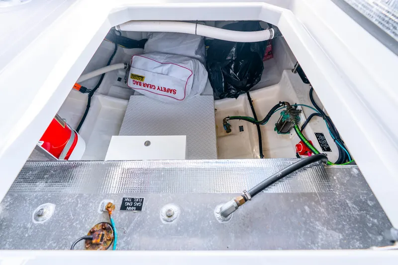 Slide: The Image of 2024 Cruisers Yachts 34 GLS OB storage compartment with safety gear and equipment. - 38