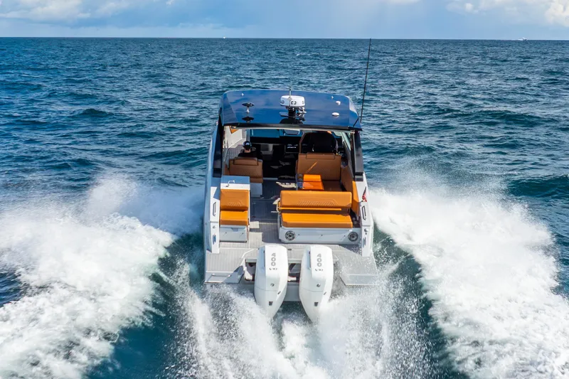 Slide: The Image of 2024 Cruisers Yachts 34 GLS OB cruising on open water, rear view. - 6