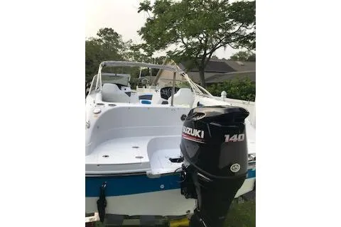 Slide: The Image of 2020 Hurricane SunDeck 191 OB boat with Suzuki 140 outboard motor, docked outdoors. - 3