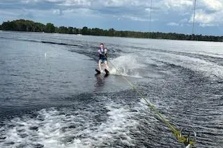 Slide: The Image of Person waterskiing behind 2020 Hurricane SunDeck 191 OB on a lake. - 8