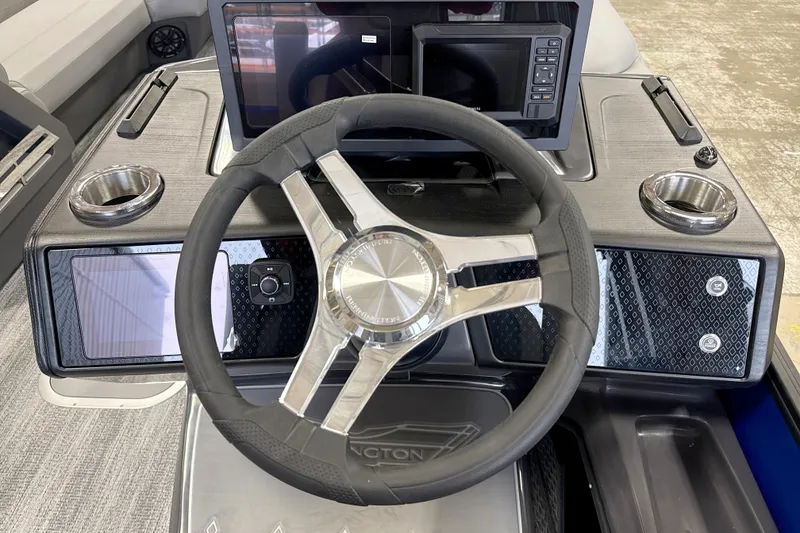 Slide: The Image of 2026 Bennington 24 MSB boat dashboard with modern steering wheel and digital displays. - 3