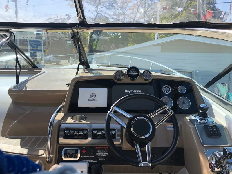 Slide: The Image of 2013 Formula 350 Sun Sport boat dashboard with steering wheel and navigation instruments. - 11