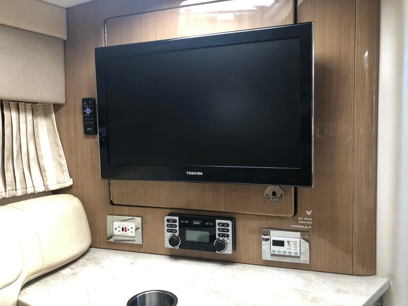 Slide: The Image of Entertainment system in 2013 Formula 350 Sun Sport boat interior with TV and control panel. - 15