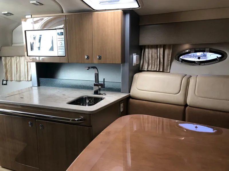 Slide: The Image of Interior of 2013 Formula 350 Sun Sport boat with kitchenette and seating area. - 17