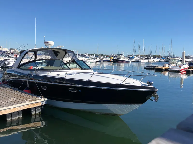 Slide: The Image of 2013 Formula 350 Sun Sport boat docked in a marina under clear blue skies. - 2