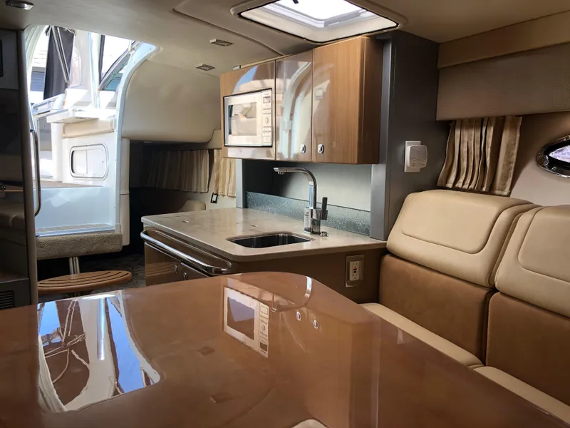 Slide: The Image of Interior of a 2013 Formula 350 Sun Sport boat with modern kitchen and seating area. - 20