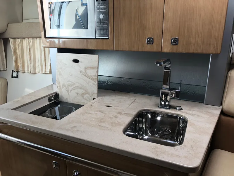 Slide: The Image of Modern kitchenette in 2013 Formula 350 Sun Sport boat with sink, stove, and microwave. - 22