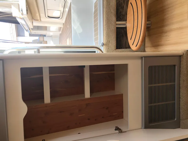 Slide: The Image of Interior of 2013 Formula 350 Sun Sport boat with wooden cabinetry and seating area. - 23