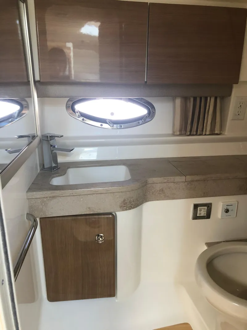 Slide: The Image of 2013 Formula 350 Sun Sport bathroom with sink, mirror, and porthole window. - 24