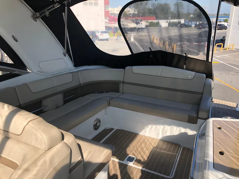 Slide: The Image of 2013 Formula 350 Sun Sport boat interior with beige seating and wood flooring. - 28