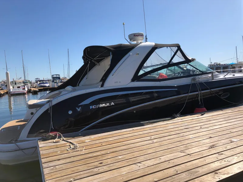 Slide: The Image of 2013 Formula 350 Sun Sport boat docked at a marina under clear blue skies. - 3