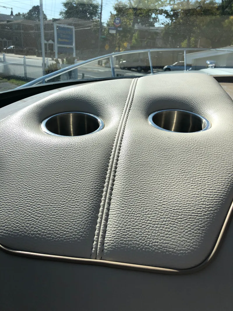 Slide: The Image of 2013 Formula 350 Sun Sport boat interior with dual cup holders on leather surface. - 34