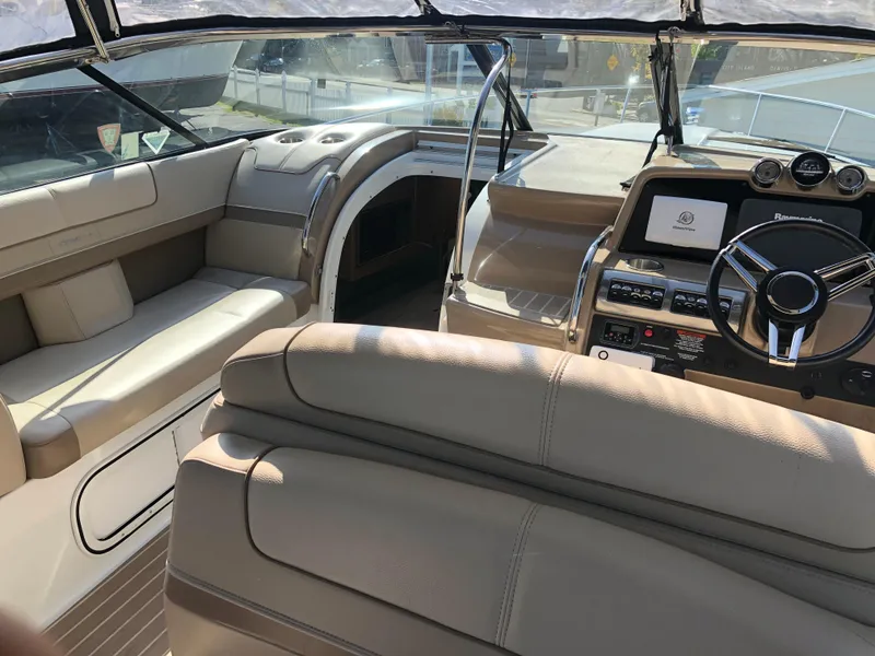 Slide: The Image of 2013 Formula 350 Sun Sport boat interior with beige seating and modern dashboard. - 35