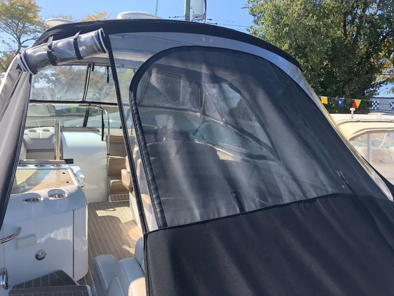 Slide: The Image of 2013 Formula 350 Sun Sport boat with black canopy and sleek interior design. - 4