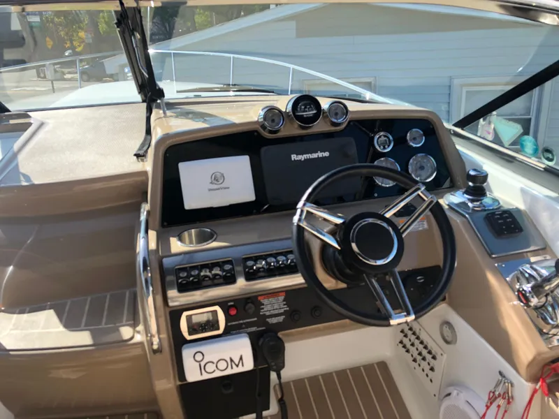 Slide: The Image of 2013 Formula 350 Sun Sport boat dashboard with steering wheel and navigation controls. - 7